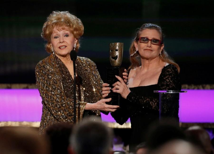 Actress Debbie Reynolds (L) accepts the life achievement award from her daughter actress Carrie Fisher at the 21st annual Screen Actors Guild Awards in Los Angeles, California January 25, 2015. Debbie Reynolds and Carrie Fisher,Debbie Reynolds,Carrie Fisher,Debbie Reynolds and Carrie Fisher rare pics,Debbie Reynolds and Carrie Fisher pics,Debbie Reynolds and Carrie Fisher images,Debbie Reynolds and Carrie Fisher photos,Debbie Reynolds and Carrie