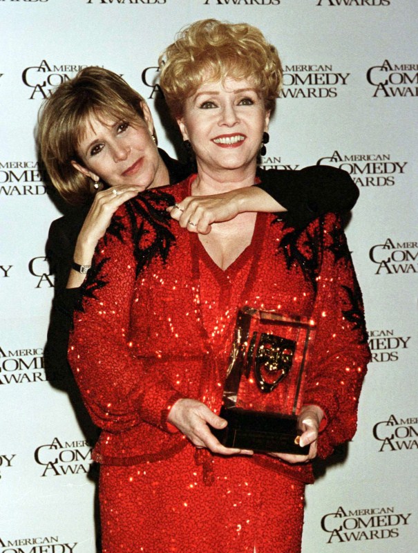 Actress Debbie Reynolds holds the Lifetime Achievement Award in Comedy for a Female which she received at the 11th annual American Comedy Awards in Los Angeles, February 9, 1997, as she poses with her daughter Carrie Fisher. Reynolds stars in the new film "Mother." Debbie Reynolds and Carrie Fisher,Debbie Reynolds,Carrie Fisher,Debbie Reynolds and Carrie Fisher rare pics,Debbie Reynolds and Carrie Fisher pics,Debbie Reynolds and Carrie Fisher images,Debbie Reynolds and Carrie Fisher photos,Debbie Reynolds and Carrie