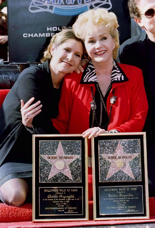 Actress Debbie Reynolds poses with her daughter actress Carrie Fisher (L) after Reynolds star in the live theatre and stage category was unveiled on the Hollywood Walk of Fame during ceremonies January 13, 1997. Debbie Reynolds and Carrie Fisher,Debbie Reynolds,Carrie Fisher,Debbie Reynolds and Carrie Fisher rare pics,Debbie Reynolds and Carrie Fisher pics,Debbie Reynolds and Carrie Fisher images,Debbie Reynolds and Carrie Fisher photos,Debbie Reynolds and Carrie