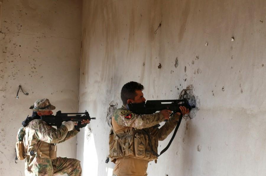 Iraqi security forces take cover during clashes with Islamic State militants, north of Mosul. Second phase of Mosul,Mosul,Mosul offensive begins,Islamic State militants,Iraqi security forces,Islamic State,Battle of Mosul