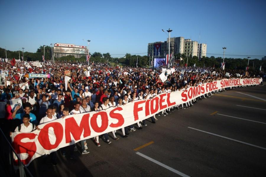 People march with a banner that reads "We are all Fidel". Cuba paraded troops and hundreds of thousands of citizens through its emblematic Revolution Square on Monday in a traditional show of nationalist fighting spirit in the face of steep economic and diplomatic challenges. Cuba,Cuba parades troops,Granma yacht,Castro brothers,60th anniversary of the landing of the Granma yacht,strength of Granma yacht,Mexico to Cuba,Armed Forces Day