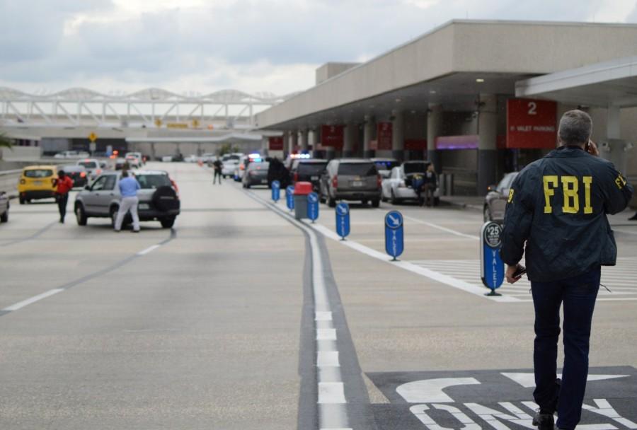 Law enforcement walk outside a terminal after a shooter opened fire at a baggage carousel at Fort Lauderdale-Hollywood International Airport in Florida, January 6, 2017. Fort Lauderdale airport,Shooting at Fort Lauderdale airport,Fort Lauderdale airport shooting,gunman,Fort Lauderdale-Hollywood International Airport