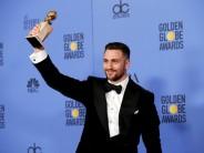 Actor Aaron Taylor-Johnson holds the award for Best Performance by an Actor in a Supporting Role in any Motion Picture for his role in "Nocturnal Animals" during the 74th Annual Golden Globe Awards