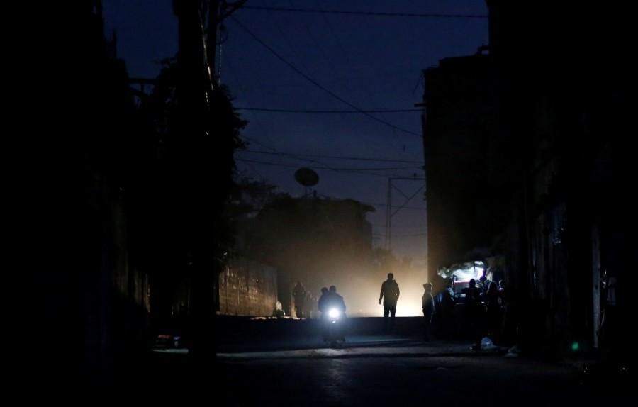 Palestinians ride a motorcycle during a power cut on a street in Beit Lahiya in the northern Gaza Strip. Lights out in Gaza,Gaza Lights out,darkened streets,Beit Lahiya,northern Gaza Strip