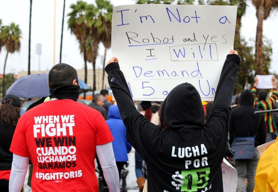 Local fast food workers take part in a nationwide protests to denounce President-elect Donald Trump's nomination of Andy Puzder, a restaurant mogul who owns Carl's Jr. and other chains, as Secretary of Labor outside a Carl's Jr. restaurant in Los Angeles, California. Donald Trump,Fight for $15,labor secretary nominee,Donald Trump labor secretary nominee,President-elect Donald Trump,against Andrew Puzder,Andrew Puzder