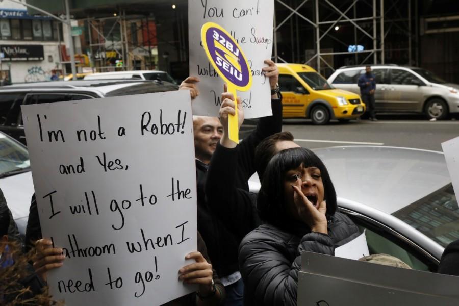 Demonstrators protest the nomination of Chief executive officer of CKE Restaurants, Andy Puzder, as Secretary of Labor in New York. Donald Trump,Fight for $15,labor secretary nominee,Donald Trump labor secretary nominee,President-elect Donald Trump,against Andrew Puzder,Andrew Puzder