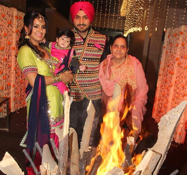 Photos of Harbhajan Singh and Geeta Basra celebrate Lohri festival with daughter Hinaya. Harbhajan Singh and Geeta Basra,Harbhajan Singh,Geeta Basra,daughter Hinaya,Hinaya,Lohri festival,Lohri festival celebrations,Harbhajan Singh with daughter Hinaya,Harbhajan Singh with Hinaya,Geeta Basra with daughter Hinaya,Geeta Basra with Hinaya