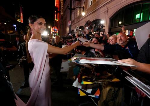Cast member Deepika Padukone signs autographs at the premiere of 