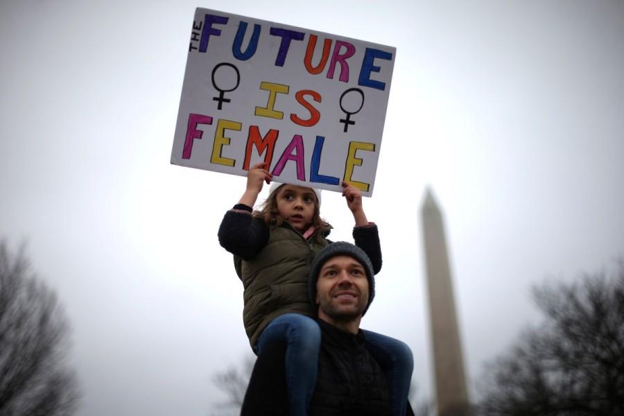 Khalil Hymore Quasha, 39, (C) and his daughter Norah Quasha, 6, participate in the Women's March on Washington. Donald Trump,President Donald Trump,Women march on Washington,Women march,United States,protest against Donald Trump