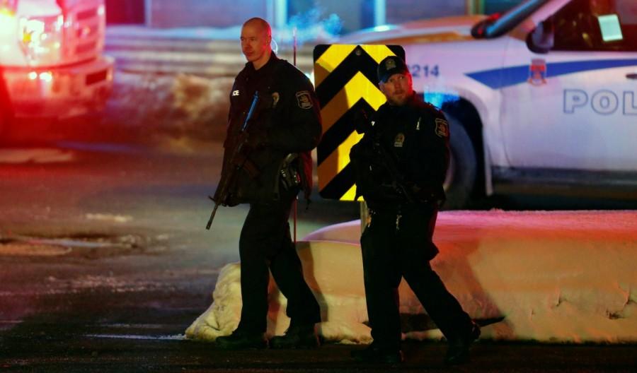 Police officers patrol the perimeter near a mosque after a shooting in Quebec City, January 29, 2017. Deadly shooting,shooting at Quebec mosque,Quebec mosque,Quebec City mosque,evening prayers