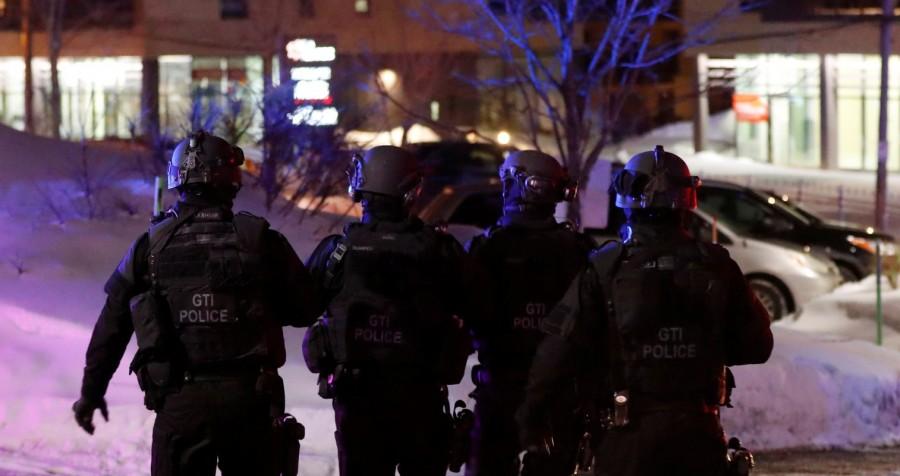 SWAT team police officer walk around a mosque after a shooting. Deadly shooting,shooting at Quebec mosque,Quebec mosque,Quebec City mosque,evening prayers