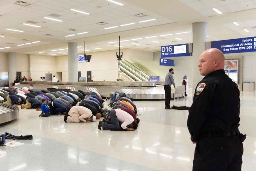 People gather to pray in baggage claim during a protest against the travel ban imposed by U.S. President Donald Trump's executive order, at Dallas/Fort Worth International Airport in Dallas, Texas, January 29, 2017. #NoMuslimBan,No Muslim Ban,NoMuslimBan,Trump's travel ban,Donald Trump,Protests erupt over Donald Trump,Muslim,Muslim ban