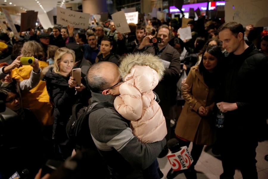 The Bay family is reunited after Hamed Bay was separated from other passengers and questioned as a result of U.S. Donald Trump's executive order travel ban, at Logan Airport in Boston, Massachusetts, U.S. January 28, 2017. Hamed Bay was traveling back to the U.S. after visiting his sick father in Iran. Trump,Donald Trump,Muslim immigrants,Muslim immigrants ban,ban Muslim immigrants,United States,President Trump,U.S.-bound flights