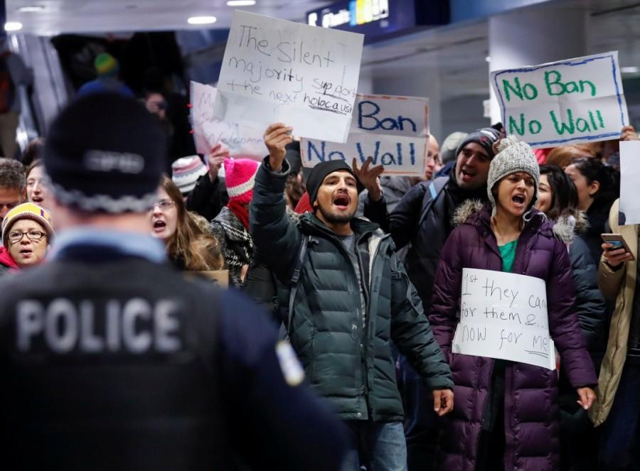 People gather to protest against the travel ban imposed by U.S. President Donald Trump's executive order, at O'Hare airport in Chicago. Trump,Donald Trump,Muslim immigrants,Muslim immigrants ban,ban Muslim immigrants,United States,President Trump,U.S.-bound flights