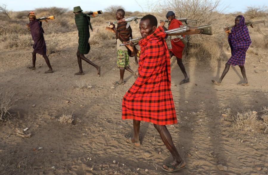 Turkana tribesmen walk with guns in order to protect their cattle from rival Pokot and Samburu tribesmen near Baragoy, Kenya. Armed cattle herders have been flooding onto farms and wildlife conservancies in drought-ravaged northern Kenya, leading to violence in which at least 11 people have been killed and a tourist lodge torched, residents said. Cattle rustling,Drought stokes,Kenyan cattle herders,northern Kenya,Kenya,political rivalries,ethnic tribes,tribes