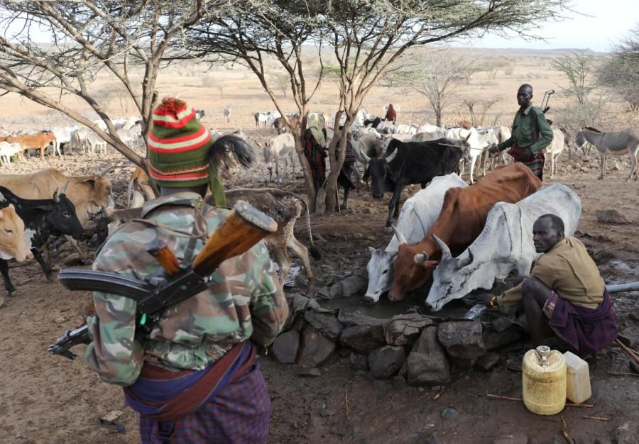 Turkana armed tribesmen stand around a borehole in order to protect their cattle near Baragoy, Kenya. Cattle rustling and competition for grazing have long troubled the area, which is a popular safari destination for visitors, but severe drought and political rivalries ahead of the elections have exacerbated the situation, residents said. Cattle rustling,Drought stokes,Kenyan cattle herders,northern Kenya,Kenya,political rivalries,ethnic tribes,tribes