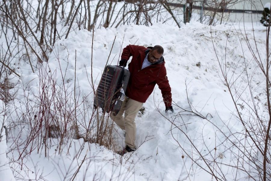 A man from Yemen crosses the U.S.-Canada border into Hemmingford, Quebec, Canada February 14, 2017. Refugees in the United States fearing a worsening climate of xenophobia in the wake of a divisive U.S. presidential campaign are flocking to Canada in growing numbers. Hemmingford,U.S.-Canada border,Canada from the U.S,Quebec,cross by foot,U.S. border,Canada border