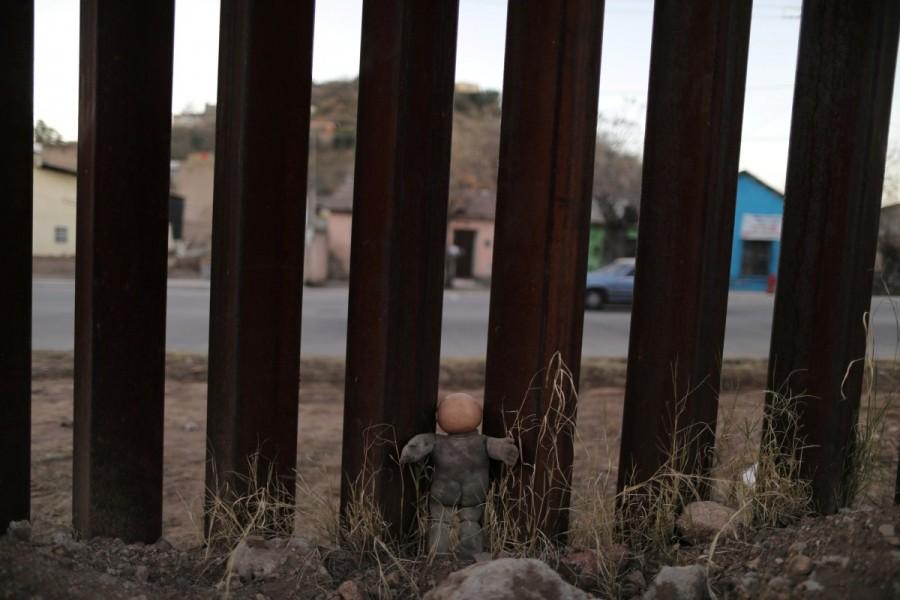A doll is seen propped against the U.S. border fence with Mexico in Nogales, Arizona. U.S. border,U.S.,Mexican,Tomatoes,peppers,cucumbers,Nogales,Arizona