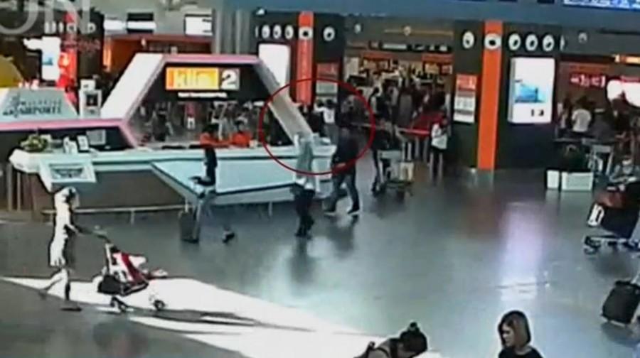 A still image from a CCTV footage appears to show (circled in red) a man purported to be Kim Jong Nam being accosted by a woman in a white shirt at Kuala Lumpur International Airport in Malaysia on February 13, 2017. Malaysian authorities,Kim Jong Un,Kim Jong Un death,death of Kim Jong Un,Kim Jong Un murder,Kim Jong Un brother murder