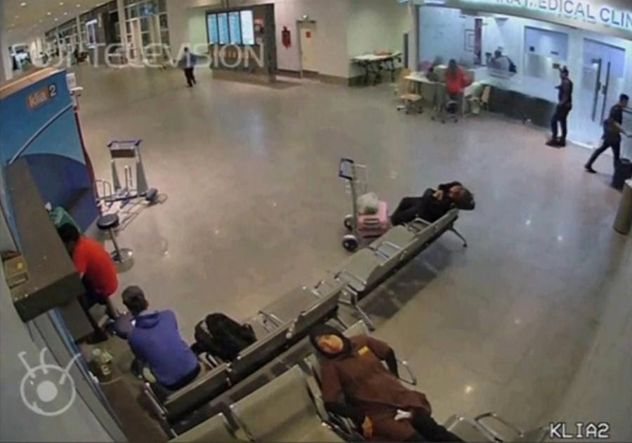A still image from a CCTV footage appears to show a man purported to be Kim Jong Nam (3rd R with black backpack) at a counter in an area with a sign reading "medical clinic", after he was accosted by a woman in a white shirt, at Kuala Lumpur International Airport in Malaysia on February 13, 2017. Malaysian authorities,Kim Jong Un,Kim Jong Un death,death of Kim Jong Un,Kim Jong Un murder,Kim Jong Un brother murder