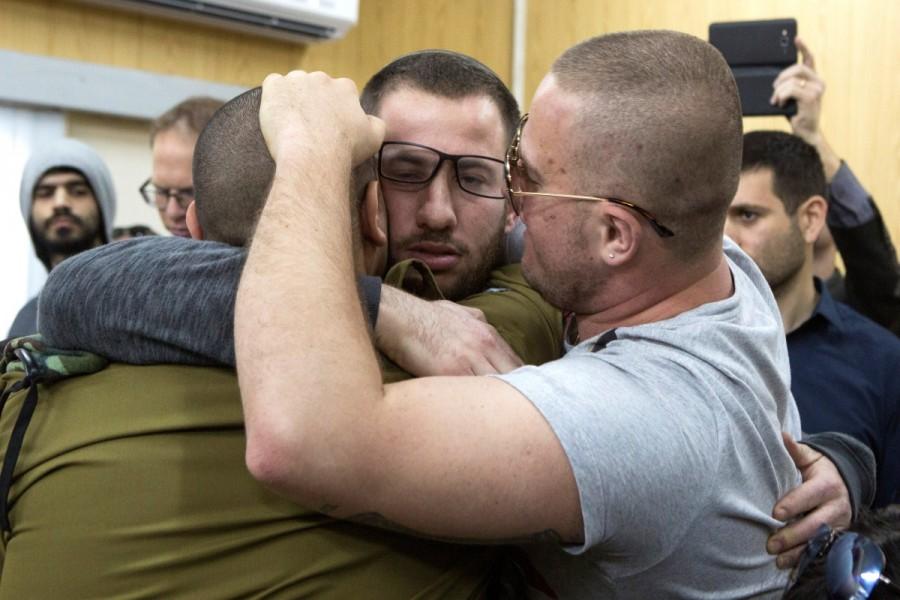 Israeli soldier Elor Azaria is embraced by his family and friends after entering a military court for his sentencing hearing at in Tel Aviv, Israel February 21, 2017. Israeli soldier,Palestinian assailant,killing Palestinian,Palestinian,Israeli soldier Elor Azaria,Elor Azaria