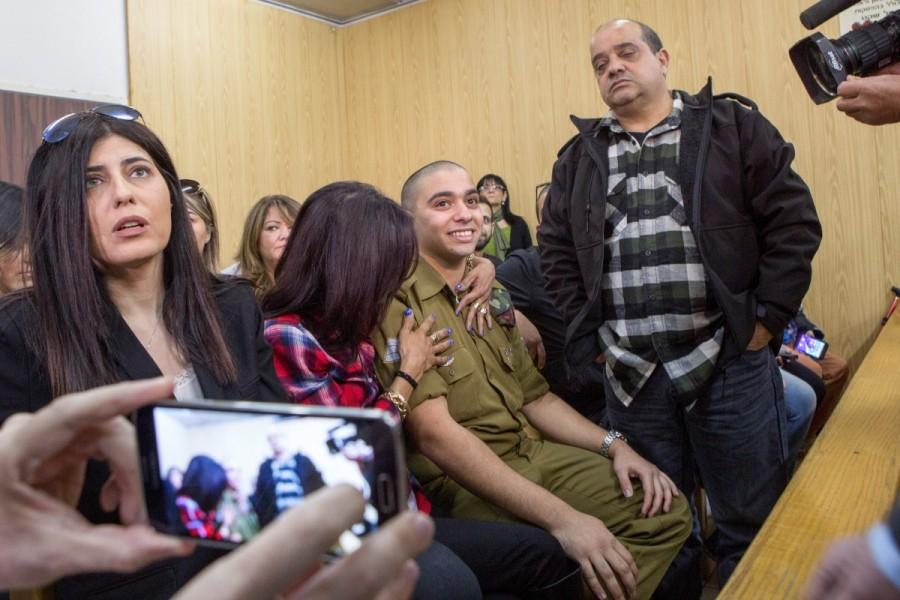 Israeli soldier Elor Azaria is embraced by his mother as his father stands nearby, at the start of is sentencing hearing at a military court in Tel Aviv, Israel February 21, 2017. Israeli soldier,Palestinian assailant,killing Palestinian,Palestinian,Israeli soldier Elor Azaria,Elor Azaria