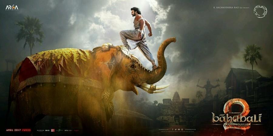 The poster looks striking, with the leading actor, Prabhas' one foot on an elephant's trunk, and the other on its head. The sight is rather glorious and powerful. It is interesting that the makers release the new poster on Maha Shivratri, as Prabhas had been shown as a devotee of Lord Shiva in the prequel, 'Baahubali: The Beginning.' One of the most iconic and loved scenes was when Prabhas shows astounding strength as he carries the Shiv ling on his shoulders. It was one of the most captivating scenes which is still remembered really fondly by the fans. Prabhas,Baahubali 2,Maha Shivaratri,Baahubali 2 special poster,Baahubali 2 poster,Baahubali: The Conclusion,Baahubali: The Conclusion poster,Baahubali: The Conclusion special poster