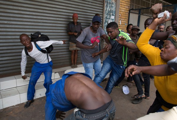 A vigilante mob attacks a Nigerian migrant outside a church in Pretoria, South Africa February 18, 2017. Somali immigrants,South African,Nigerian migrant,Pretoria,South African mobs,immigrants attack