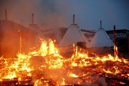 A building burns after it was set alight by protesters preparing to evacuate the main opposition camp against the Dakota Access oil pipeline near Cannon Ball, North Dakota.