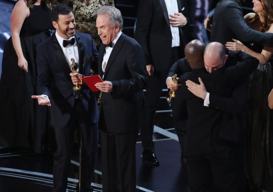 Jimmy Kimmel talks to Warren Beatty as Jordan Horowitz and Barry Jenkins hug, during presentation for Best Picture. La La Land,Moonlight,2017 Oscars,Best Picture,Best Picture of Oscars