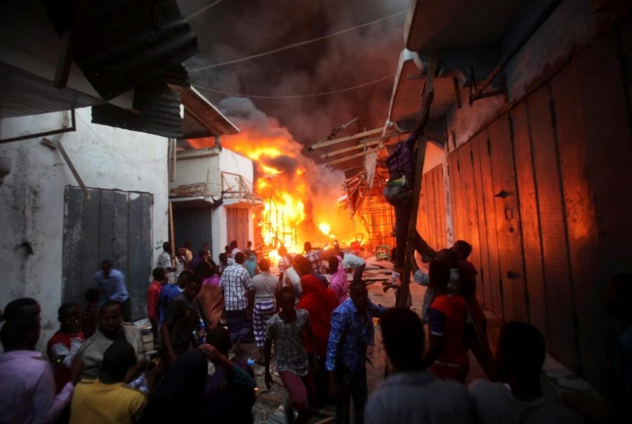 Somali traders attempt to salvage some of their wares from the burning stalls at the main Bakara market in Somalia's capital Mogadishu. Mogadishu,Mogadishu market,Bakara market,Somalia,Somalia capital