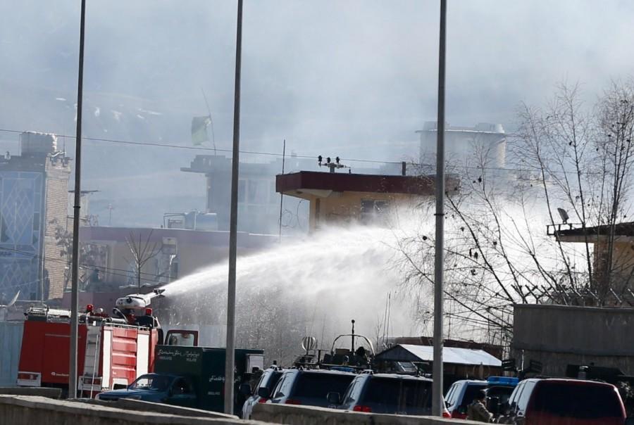 Afghan firefighters spray water as they try to extinguish fire at the site of a blast and gunfire between Taliban and Afghan forces in PD 6 in Kabul. Taliban,Taliban car bomb attack,bomb attack in Kabul,Taliban bomb attack,Afghan Taliban militants,Afghan militants,Taliban militants