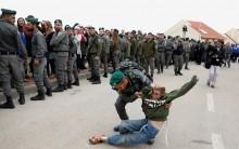 An Israeli border policeman removes a pro-settlement activist during an operation by Israeli forces to evict residents from several homes in the Israeli settlement of Ofra, in the occupied West Bank February 28, 2017.