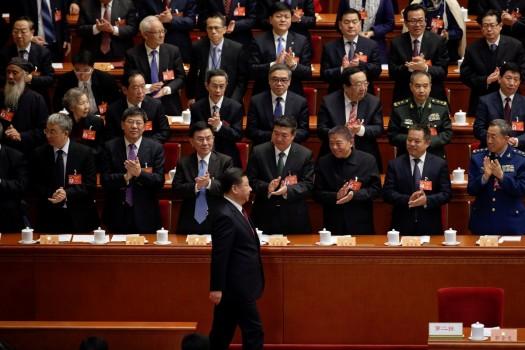 Delegates clap their hands as China's President Xi Jinping (1st row) arrives for the opening session of the Chinese People's Political Consultative Conference (CPPCC) at the Great Hall of the People in Beijing, March 3, 2017.