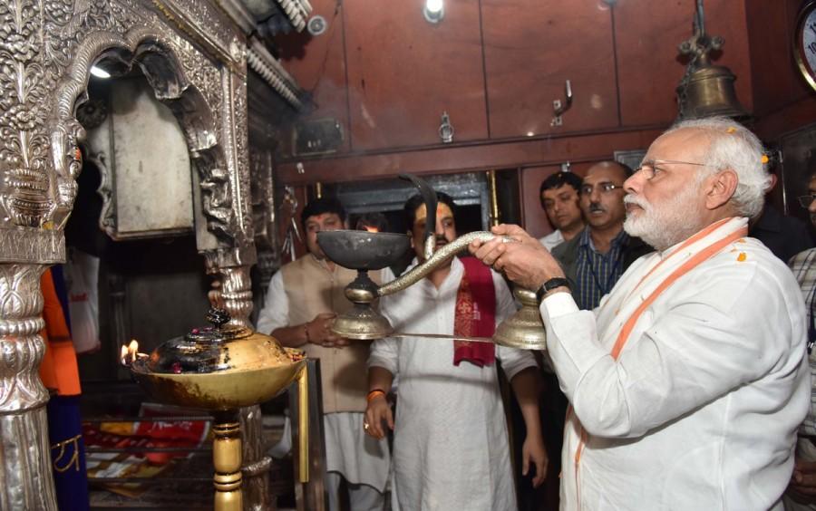 Prime Minister Narendra Modi on Saturday offered several litres of milk, Ganga jal and flowers at the fabled Kashi Vishwanath temple here and performed aarti at the sanctum sanctorum during a break in his road show. Amid tight security, the Prime Minister reached the temple at around 1:30 p.m. and paid obeisance to Lord Shiva, the presiding deity of Varanasi. Prayers were conducted by five priests headed by Acharya Ashok Dwivedi, a source informed IANS. Narendra Modi,Narendra Modi at Varanasi,Narendra Modi at Kaal Bhairav Temple,Kaal Bhairav Temple,Narendra Modi offers prayers at Kaal Bhairav Temple,Narendra Modi offers prayers at Varanasi