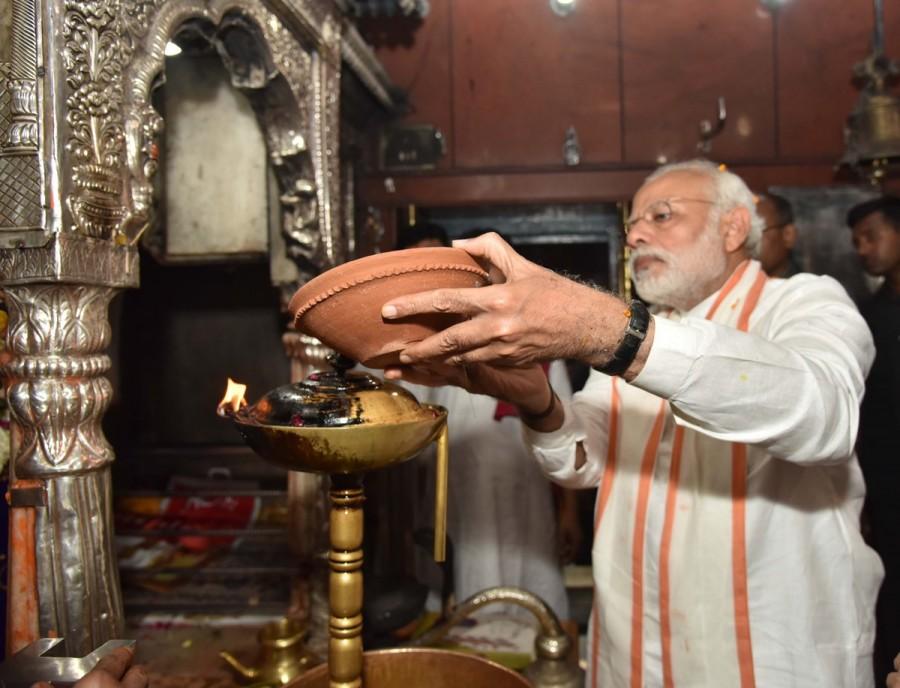Prime Minister Narendra Modi soon after his resounding victory in the 2014 Lok Sabha elections had visited the Kashi Vishwanath temple but skipped Kaal Bhairav temple. Earlier, the Prime Minister took out a road show in the city as thousands lined up the route, chanted pro-Modi slogans and showered marigold petals on his entourage. The SPG personnel surrounding the Prime Minister had a tough time controlling the milling crowds who tried to come close as he stood up through the sunroof of a bulletproof SUV. Narendra Modi,Narendra Modi at Varanasi,Narendra Modi at Kaal Bhairav Temple,Kaal Bhairav Temple,Narendra Modi offers prayers at Kaal Bhairav Temple,Narendra Modi offers prayers at Varanasi