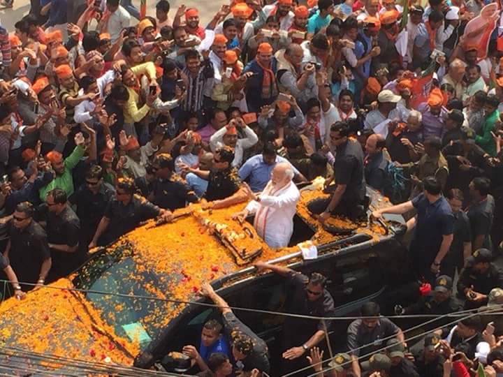 Prime Minister Narendra Modi arrived in the temple town of Varanasi on Saturday for his road show amid huge enthusiasm from his supporters here in his parliamentary constituency. Narendra Modi,Narendra Modi road show,Narendra Modi road show at Varanasi,Narendra Modi at Varanasi,Narendra Modi arrives for road show