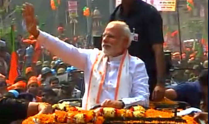 After a brief interaction he moved in his bulletproof car in a cavalcade to a guest house. Thousands of people were lined up along the routes of Modi's road show, ahead of the March 8 polls here. Narendra Modi,Narendra Modi road show,Narendra Modi road show at Varanasi,Narendra Modi at Varanasi,Narendra Modi arrives for road show