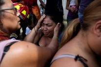 Family members react as they wait for news of their loved ones after a fire broke at the Virgen de Asuncion home in San Jose Pinula, on the outskirts of Guatemala City, Guatemala. The blaze that has killed at least 37 and maimed others at an overcrowded Guatemalan shelter for abused teens broke out in a tiny room they were locked in to control them after a riot at the center, authorities and witnesses said.