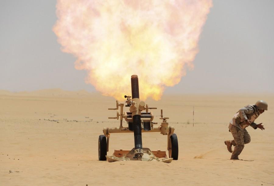 A Saudi soldier fires a mortar towards Houthi movement position, at the Saudi border with Yemen. Saudi-led Arab coalition,Saudi-led Arab,war in Yemen,Saudi Arabia's war in Yemen,Yemen,Yemen war,Iran-allied Houthi movement,Houthi movement