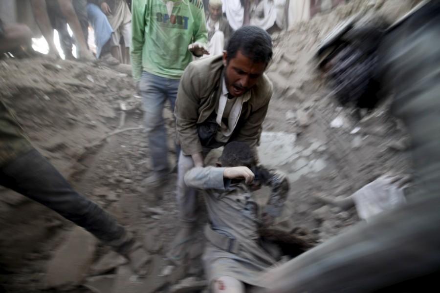 A man carries a body from the rubble of a house destroyed by an air strike at the old quarter of Yemen's capital Sanaa. At least ten Yemeni civilians were killed in air strikes by Saudi-led warplanes that targeted this neighborhood. Saudi-led Arab coalition,Saudi-led Arab,war in Yemen,Saudi Arabia's war in Yemen,Yemen,Yemen war,Iran-allied Houthi movement,Houthi movement