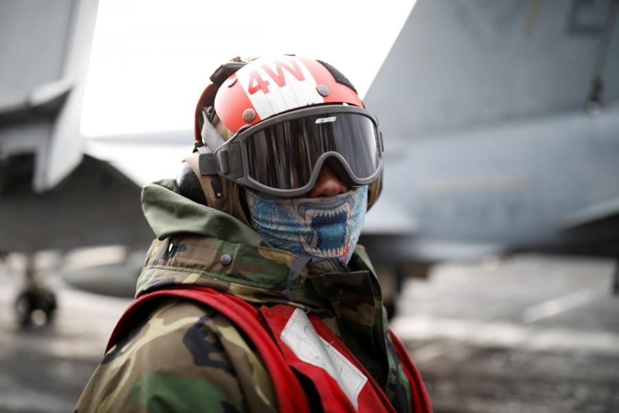 A U.S. Navy crew member works on the deck of U.S. aircraft carrier USS Carl Vinson during an annual joint military exercise called "Foal Eagle" between South Korea and U.S., in the East Sea, South Korea. U.S. aircraft,U.S. aircraft joins South Korea,South Korea drills,U.S.-South Korean drills,merciless,North Korea,North Korea warns the United States,Navy F18,U.S. Navy F18