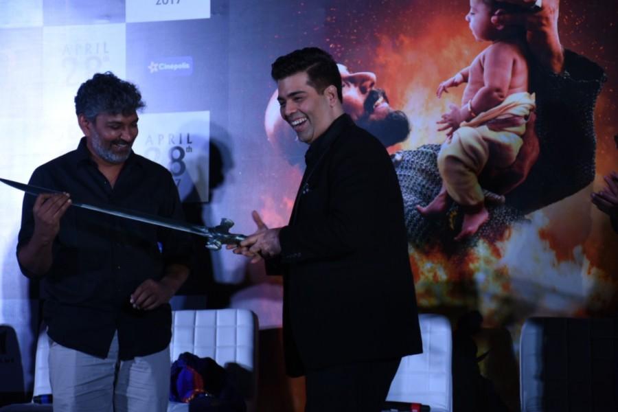 The sword was presented to Karan Johar as a token of association with the Baahubali franchise. SS Rajamouli,Kattapa,Kattapa sword,Karan Johar,Baahubali,Baahubali 2,Baahubali 2 trailer launch,Baahubali 2 trailer,Baahubali 2 trailer launch pics,Baahubali 2 trailer launch images,Baahubali 2 trailer launch photos,Baahubali 2 trailer launch stills,Baahu