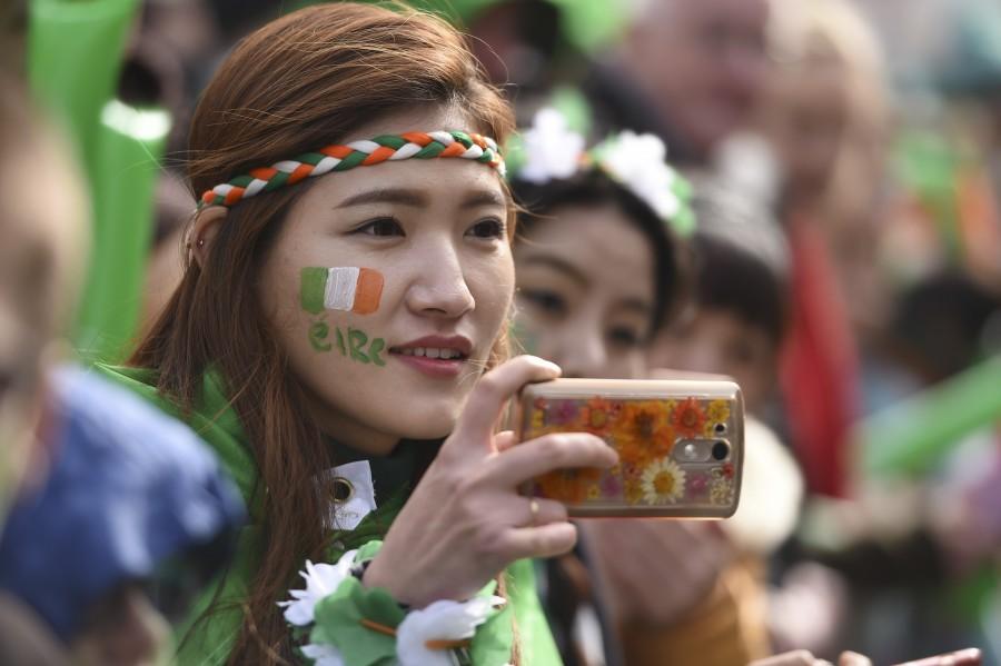 A woman takes a photo during the St. Patrick's day parade in Dublin, Ireland March 17, 2016 St Patrick’s Day,St Patrick’s Day 2017,St Patrick’s Day photos,irish holiday,St Patrick’s Day holiday,people celebrate St Patrick’s Day,St Patrick’s Day green,photos,Duchess of Cambridge,prince william,Catherine,St Patrick’s Day parade