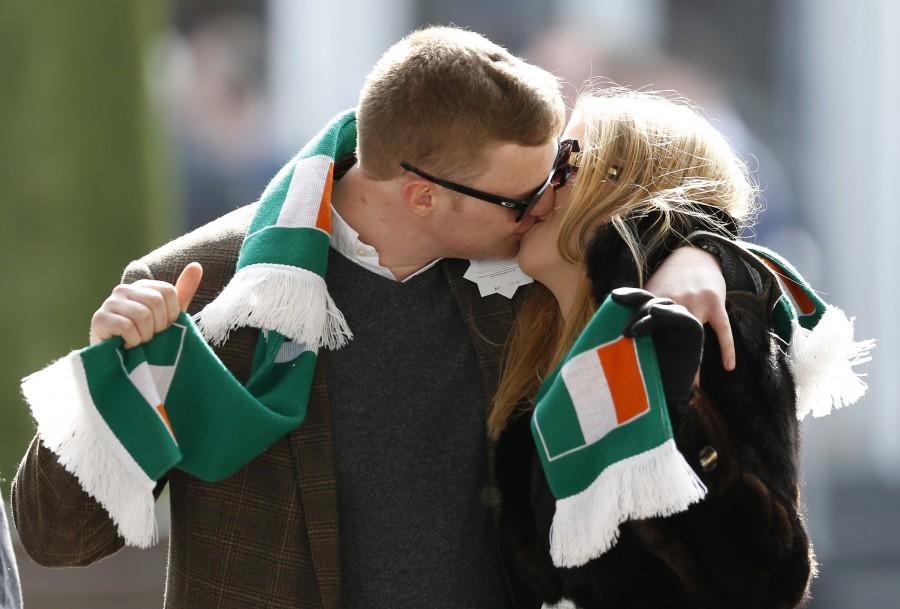 Racegoers kiss as they pose for photographers on St Patrick's Day at Cheltenham St Patrick’s Day,St Patrick’s Day 2017,St Patrick’s Day photos,irish holiday,St Patrick’s Day holiday,people celebrate St Patrick’s Day,St Patrick’s Day green,photos,Duchess of Cambridge,prince william,Catherine,St Patrick’s Day parade