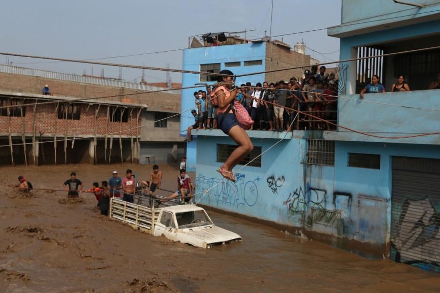 A woman gets rescued after a massive landslide and flood in the Huachipa district of Lima, Peru March 17, 2017. Floods,landslides,Floods in Peru,landslides in Peru,Peru floods