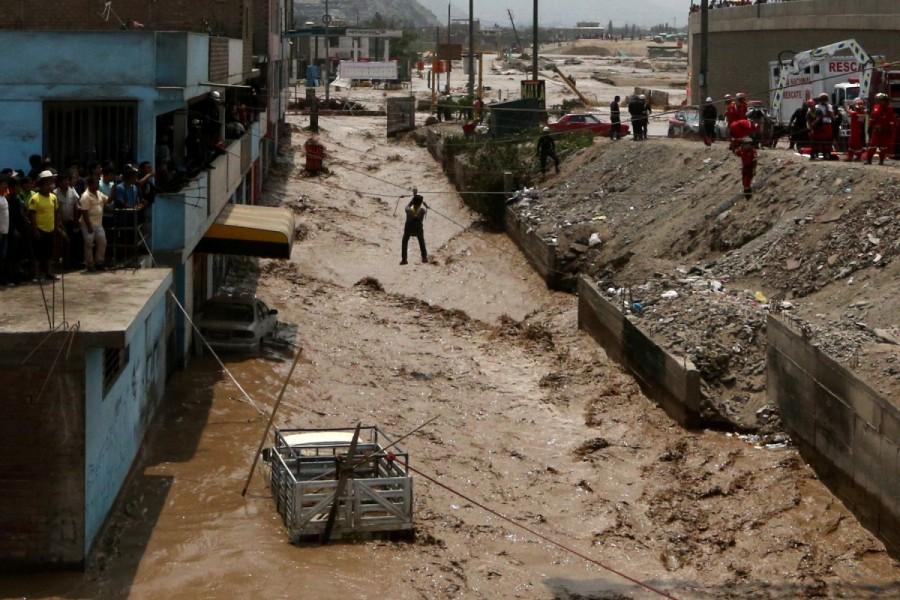 A man gets rescued after a massive landslide and flood in the Huachipa district of Lima, Peru March 17, 2017. Floods,landslides,Floods in Peru,landslides in Peru,Peru floods