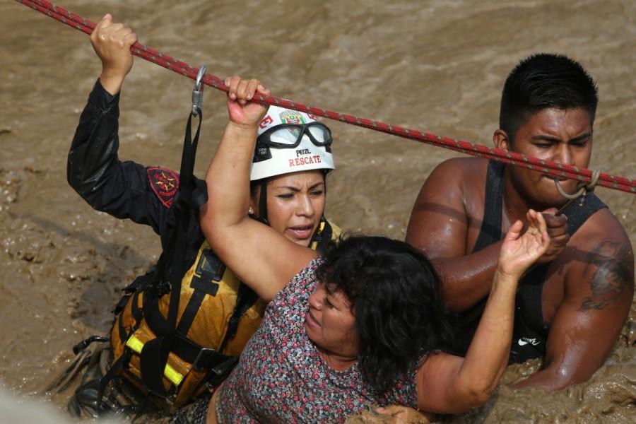 A woman gets rescued after a massive landslide and flood in the Huachipa district of Lima, Peru March 17, 2017. Floods,landslides,Floods in Peru,landslides in Peru,Peru floods