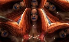 A visitor poses for a picture next to mirrors during Sao Paulo Fashion Week in Sao Paulo, Brazil, March 16, 2017.