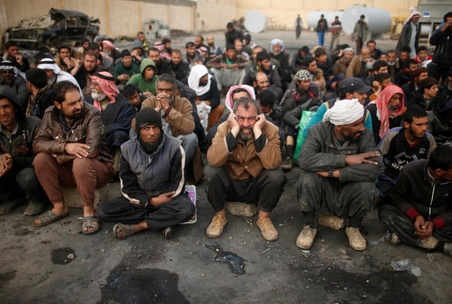 Displaced Iraqis who had fled their homes stop for a check by Iraqi forces, as Iraqi forces battle with Islamic State militants, in western Mosul. Iraqi forces,Mosul,Iraqi forces edge further into Mosul,Iraqi forces attack,Iraqi Air Force